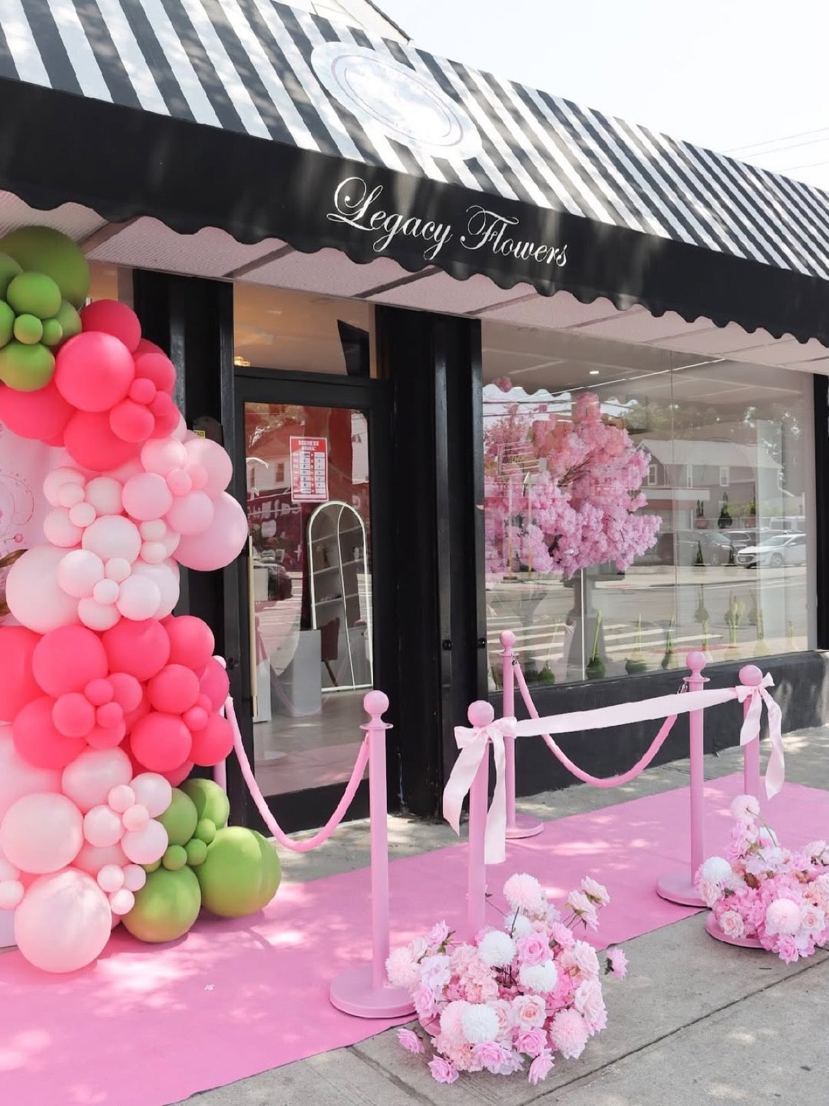 The Legacy Flowers storefront in St. Albans with its black-and-white striped awning
